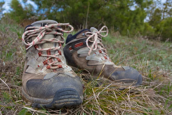 Pair of touristic boots in a grass — Stock Photo, Image