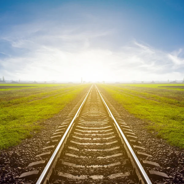 Railway leawing far to a sunrise — Stock Photo, Image