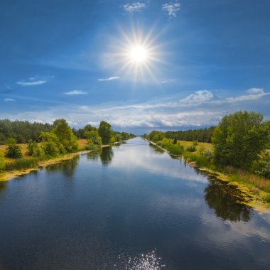 Beautiful river in a rays of sun clipart