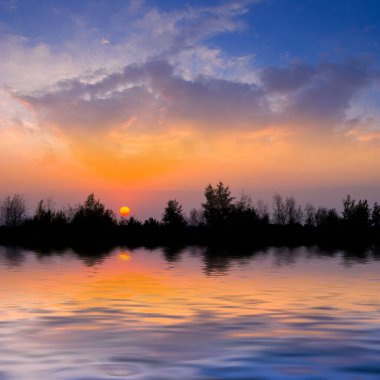 dramatic sunset over small lake, quiet natural sunset background