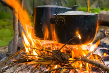 touristic cauldron on camp fire, travel camping cooking scene