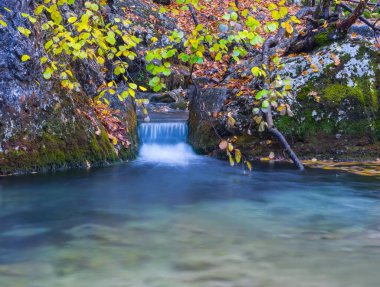 small river rushing through mountain canyon, autumn natural mountain river background