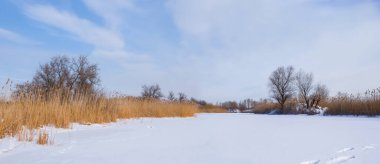 frozen river covered by snow, winter outdoor scene