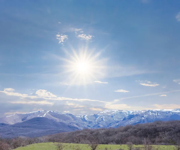 snowbound mountain ridge under a sparkle sun