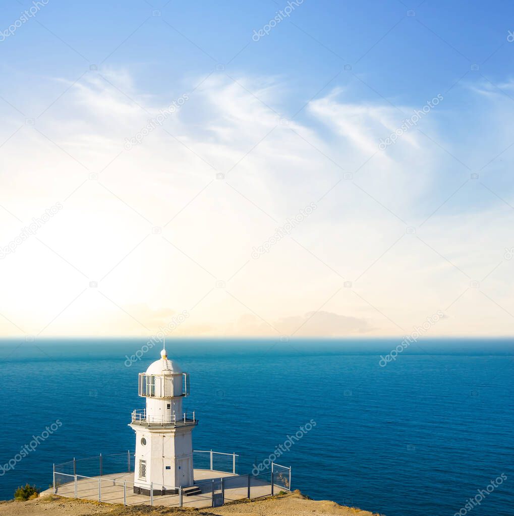 lighthouse on emerald marine cape at the sunrise