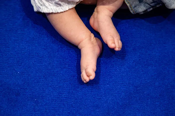 Mavi halıda 0 yaşında bir çocuk.