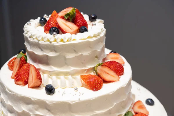 Wedding cake with cute strawberries and blueberries