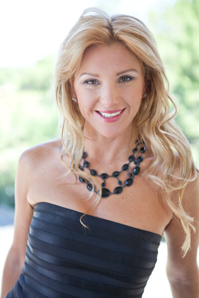 красивая женщина улыбается, глядя в камеру
