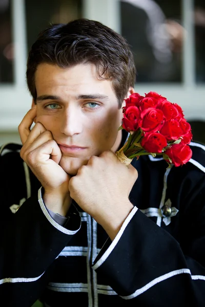 Handsome Man left with roses — Stock Photo, Image