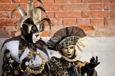 Closeup of a Jester and costumed woman Venice Italy clipart