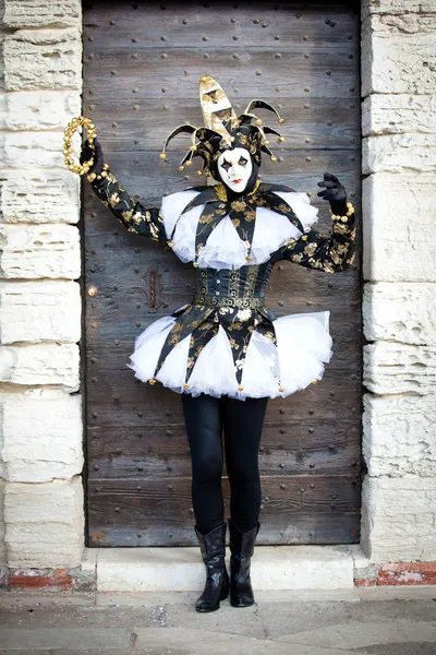 Dancing Jester in Venice Italy with a gold tamberine — Stock Photo, Image