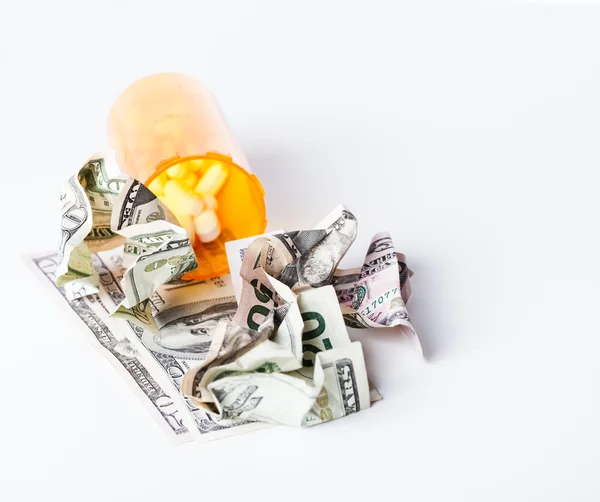 Prescription Drugs in a container with a hunderd dollar bill and — Stock Photo, Image