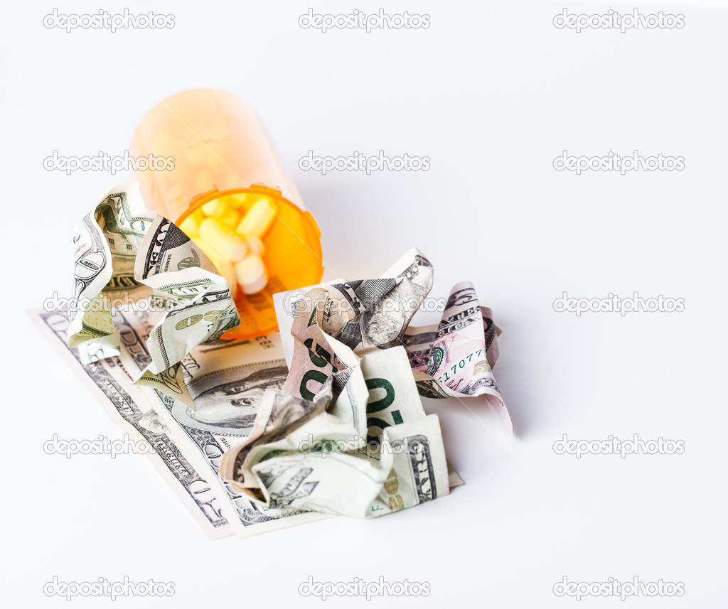 Prescription Drugs in a container with a hunderd dollar bill and