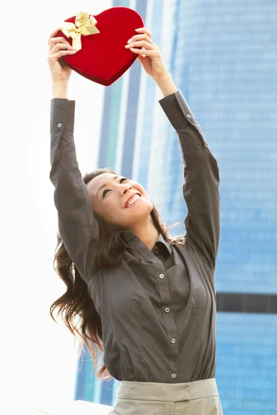 Japanese business woman with a heart held high — Stock Photo, Image