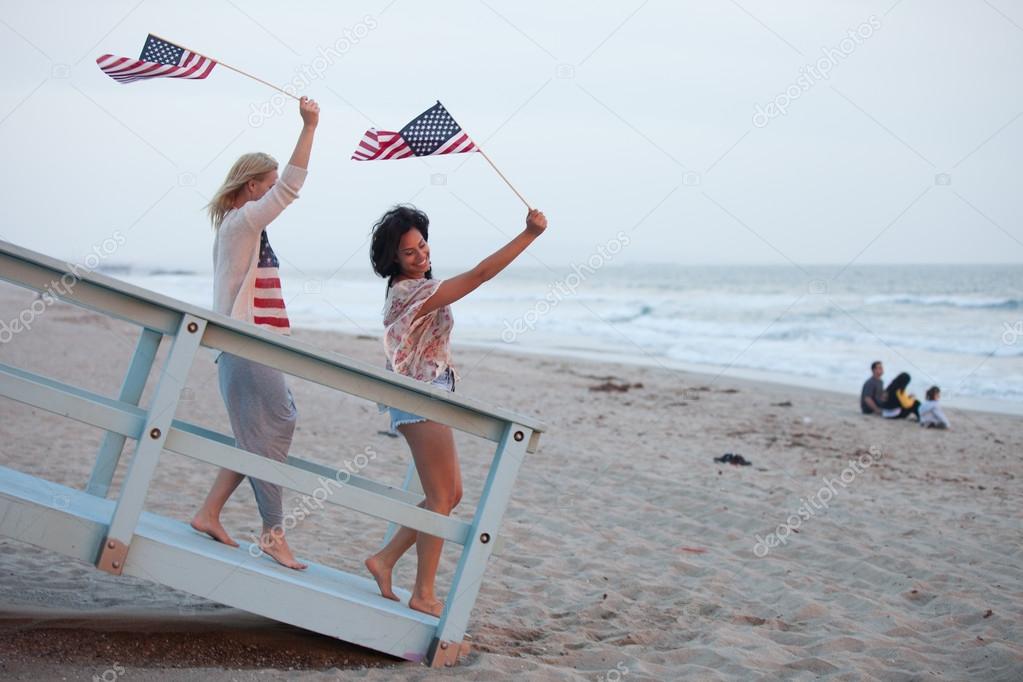 Woman at the Beach with USA flags American youth concepts