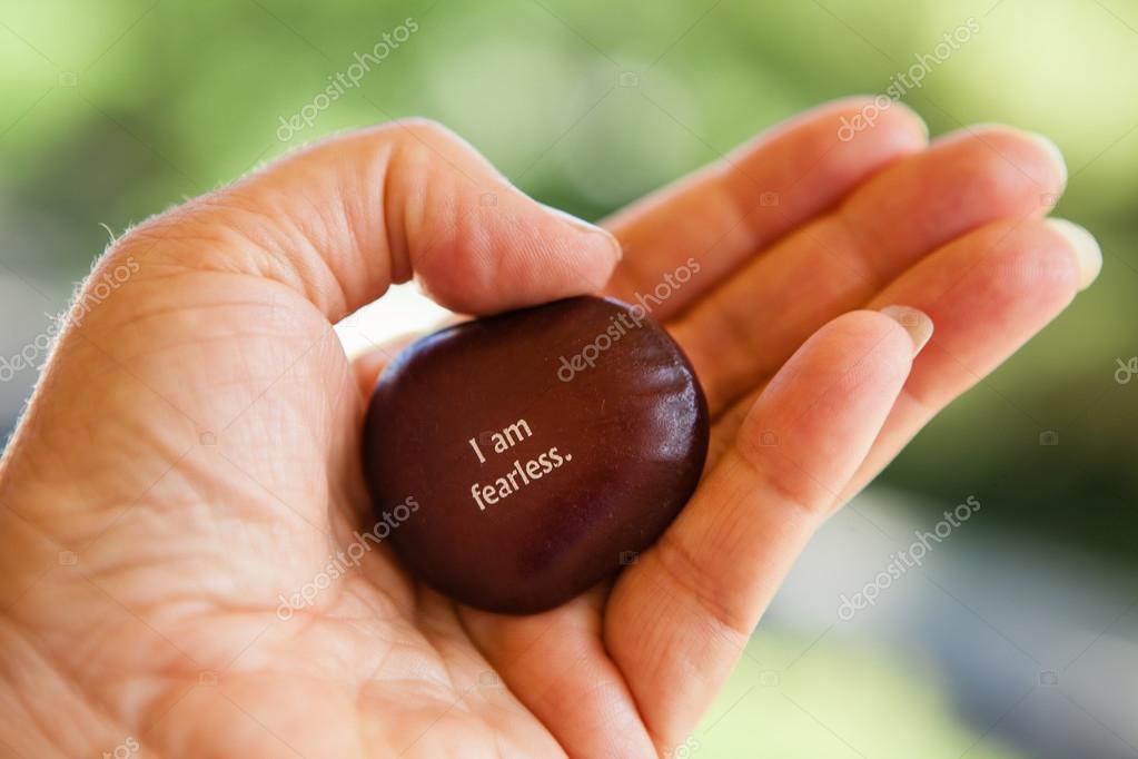 Hand holding a meditation metaphor seed with words written