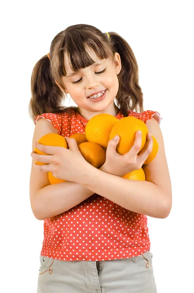 Niña sosteniendo muchas naranjas — Foto de Stock