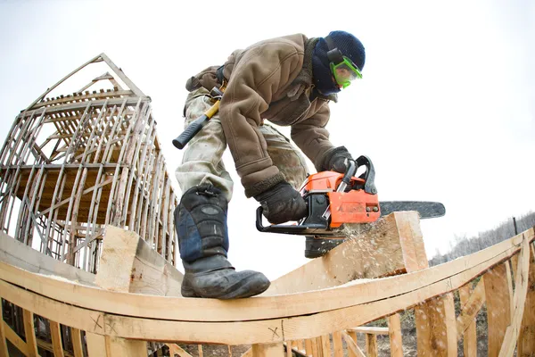 Workman with petrol-powered saw — Stock Photo, Image