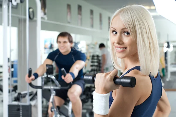 Athletic girl   with dumbbells — Stock Photo, Image