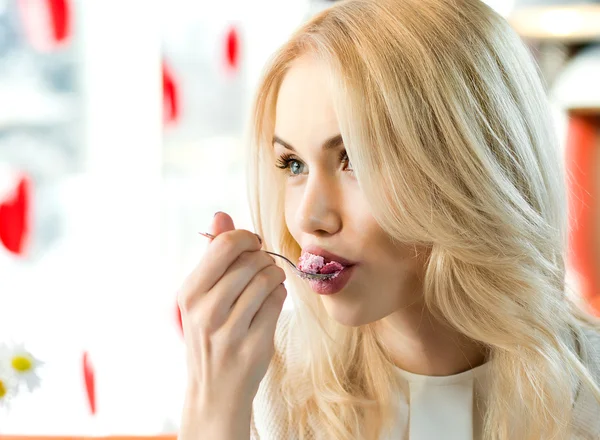 Young woman in Cafe eating dessert Royalty Free Stock Images