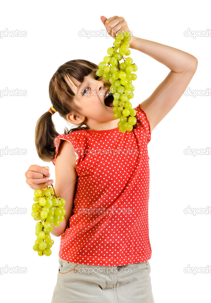 Little girl eating bunch of grapes