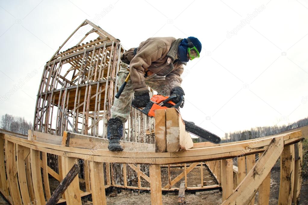 Workman with petrol-powered saw