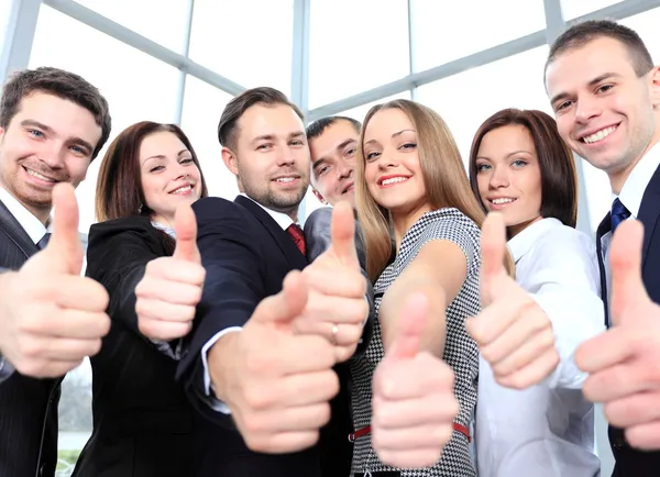 Successful young business showing thumbs up — Stock Photo, Image