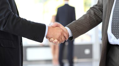 Business men closing deal with a handshake