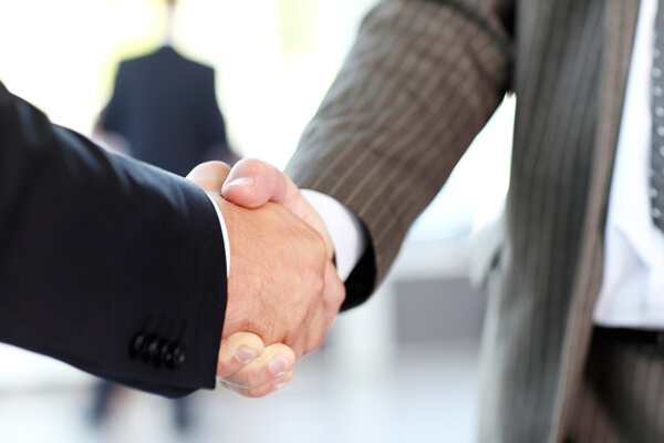 Closeup of business shaking hands over a deal