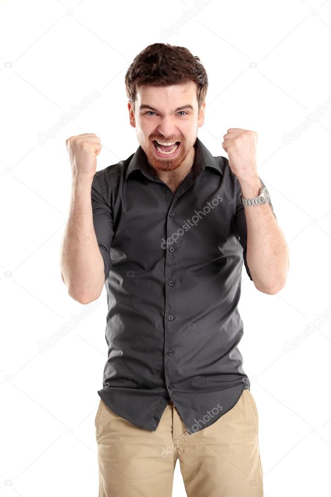 Excited handsome business man with arms raised in success
