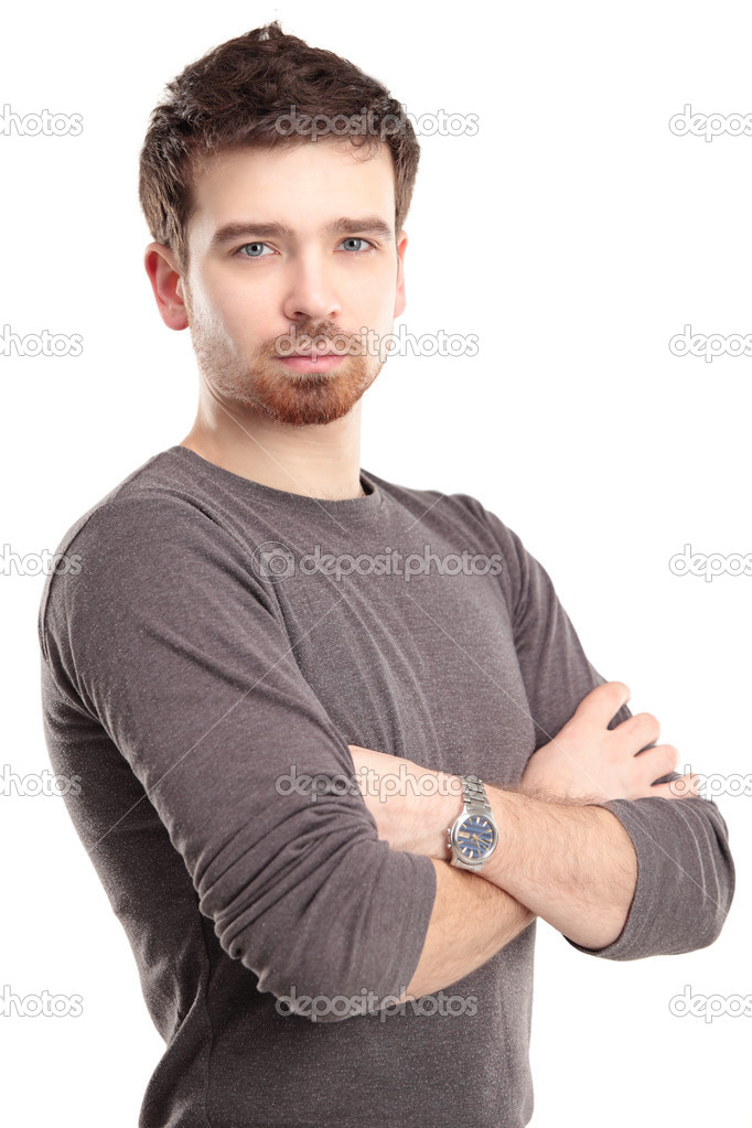 Casual young man looking at camera with arms crossed and satisfaction