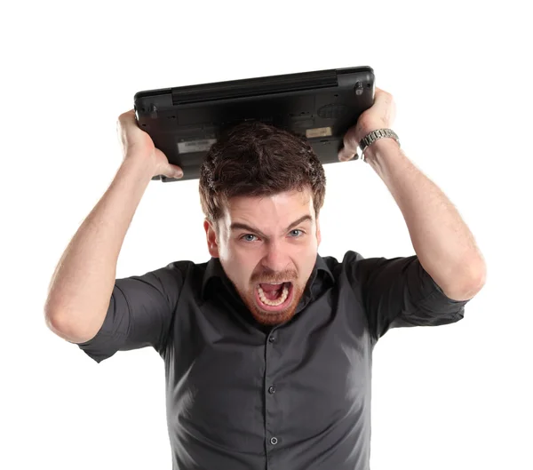 Furious businessman looking at his laptop and shouting Stock Picture