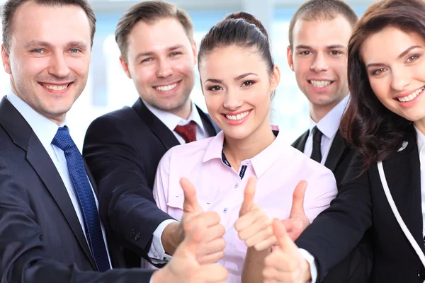 Successful young business showing thumbs up sign — Stock Photo, Image