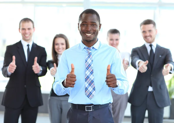 Successful young business showing thumbs up sign — Stock Photo, Image