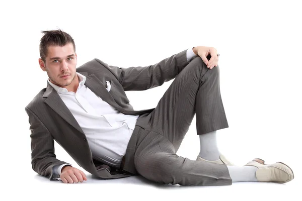 Portrait of business man sitting on the floor isolated over white background — Stock Photo, Image