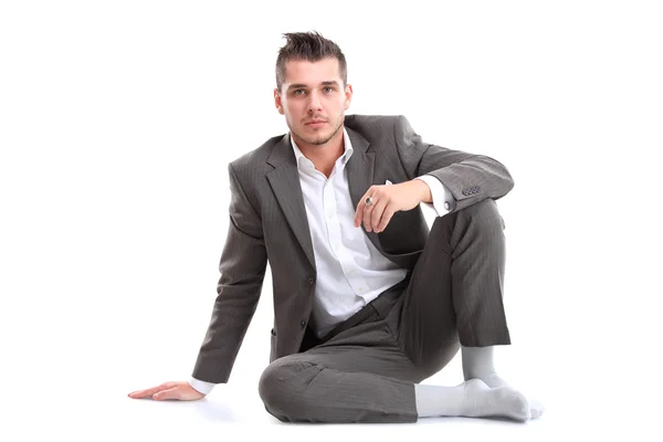 Retrato de homem de negócios sentado no chão isolado sobre fundo branco — Fotografia de Stock