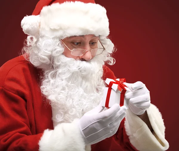 Photo of happy Santa Claus looking into white giftbox in isolation — Stock Photo, Image