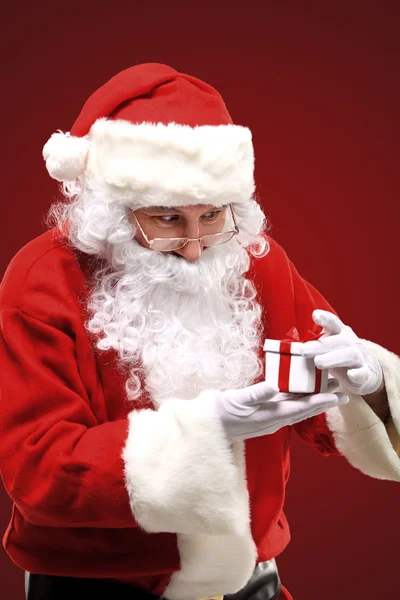 Photo of happy Santa Claus looking into white giftbox in isolation Stock Image