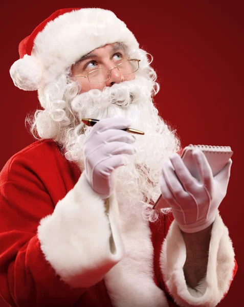 Santa claus schrijven van een lijst — Stockfoto