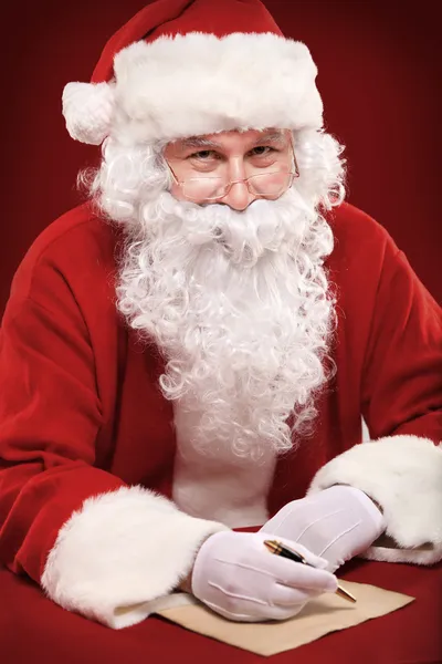 Santa Claus looking at envelope — Stock Photo, Image