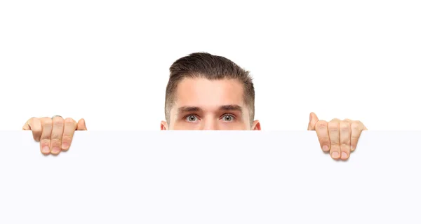 Shocked businessman holding a blank white card board, signboard, showing an empty bill board, handsome young business man, isolated over white background — Stock Photo, Image