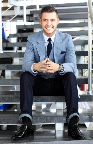 Business man sitting on stairs — Stock Photo, Image