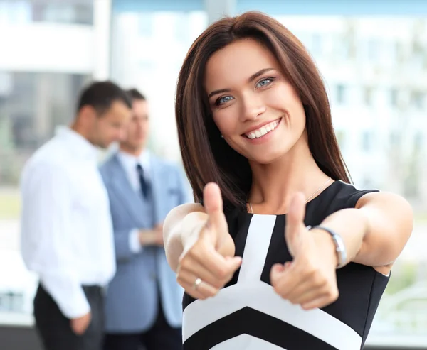 Businesswoman showing thumbs up Stock Image