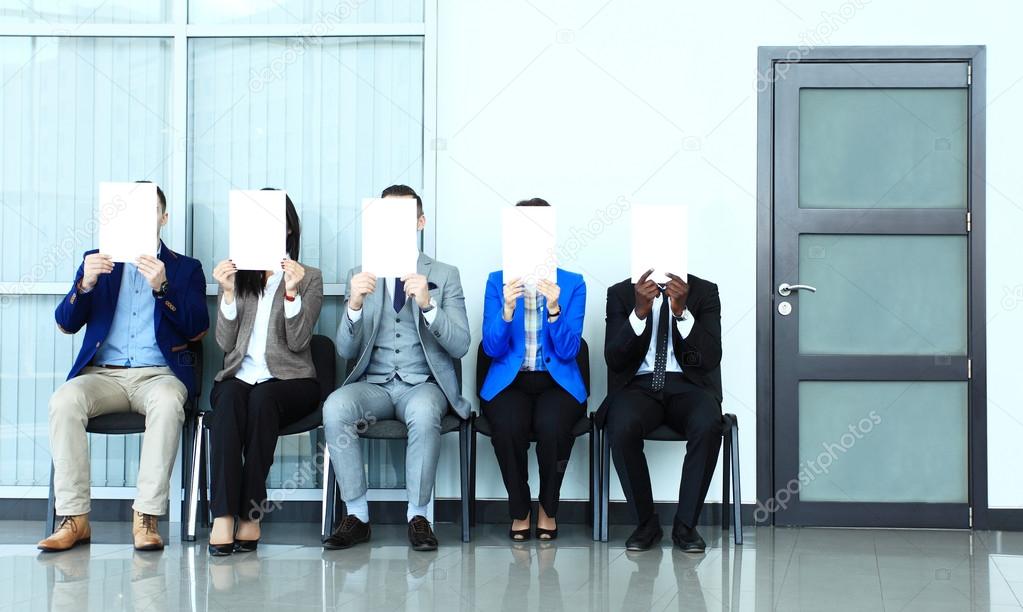 Businesspeople holding billboard