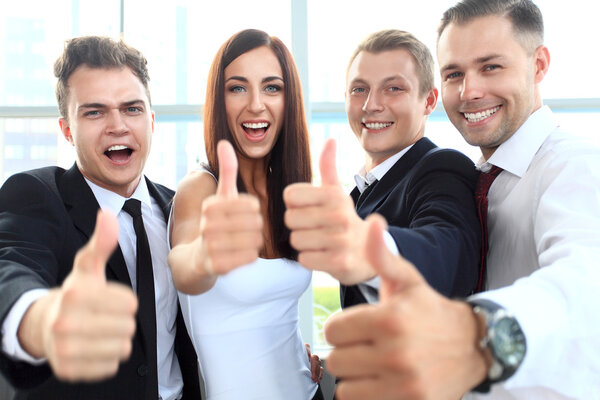 Business people showing thumbs up