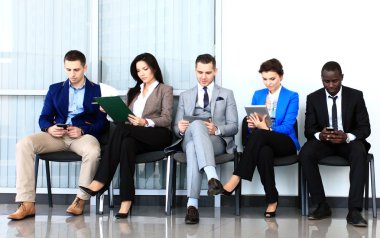 Businesspeople waiting for job interview clipart