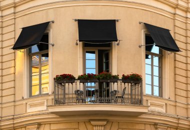 Evin ön cephesinde oturma alanı olan balkon..