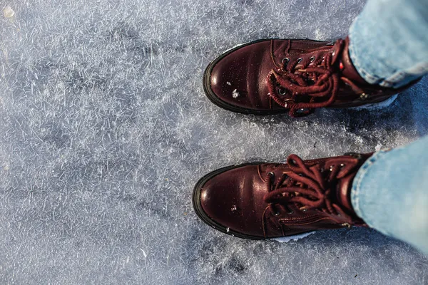 Kış geliyor. Güneşte ışıl ışıl buz kristalleri üzerinde kadın botları