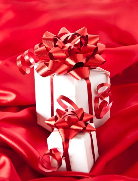 Small gifts with red bow on red background — Stock Photo, Image