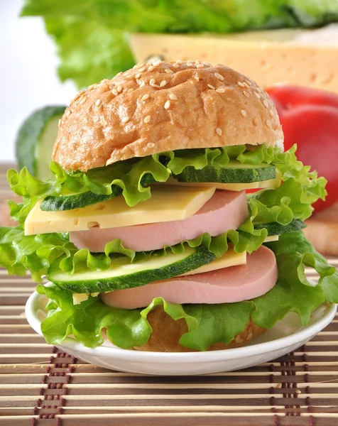 Sandwich with sausage cheese and greens — Stock Photo, Image